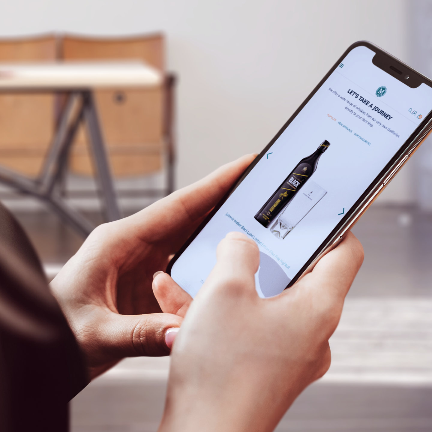Close-up of hands navigating an alcohol ecommerce store on a smartphone.
