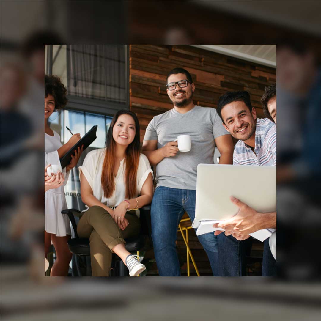 Website design and development team smiling in office.