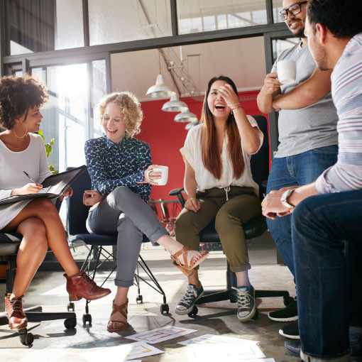 A group of employees having an open discussion in a meeting room.