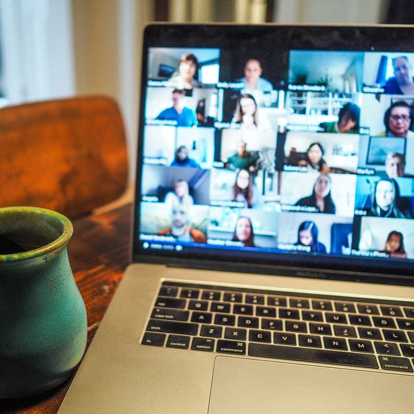 Video conference call on laptop in living room.