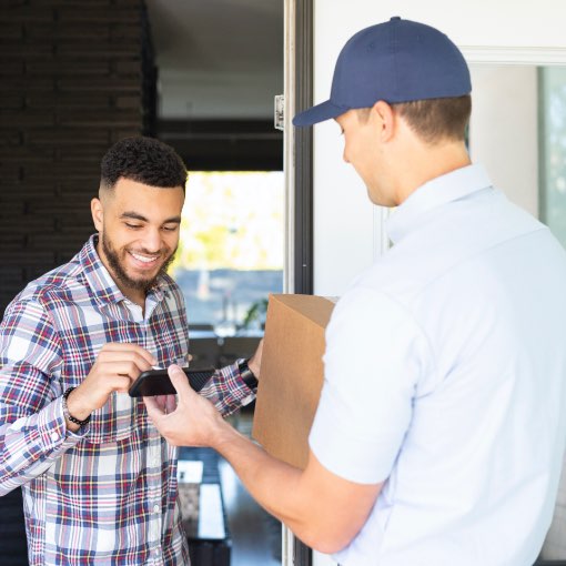 Man signing for alcohol box delivery.