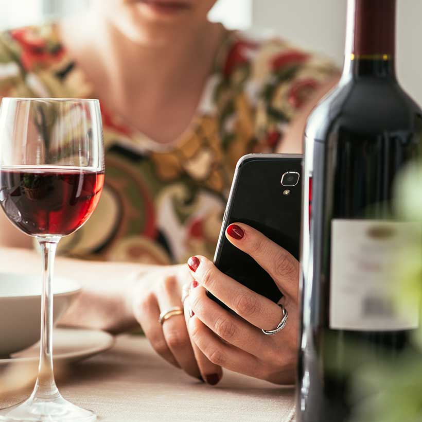 vivino-wine-app Woman using wine app.
